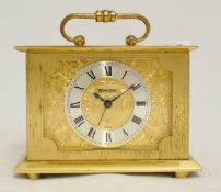 Swiza 8 day clock in brass case with handle and applied chapter ring and roman numerals, 10cm.