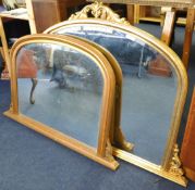 A reproduction of a Victorian gilt framed overmantle mirror and a similar pine effect mantle mirror,
