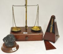 Brass and mahogany scales, a metronome and a cast iron dog inkwell (3).