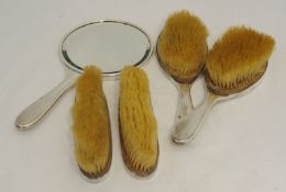 Five piece silver back dressing table set comprising four brushes and a hand mirror.