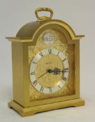 Brass cased 8 day clock with alarm Swiza, 15 jewelled lever movement. Break arch case applied