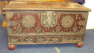 A heavy 19th century hardwood Zanzibar chest, profusely brass decorated with rising lid, candlebox