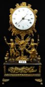 A 19th century mantle clock with circular enamel dial set above a pair gilt figures, the movement