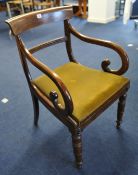 An early Victorian mahogany scroll arm carver chair.