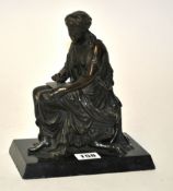 A bronze figure of neo classical style modelled as a seated female figure writing a note sat upon