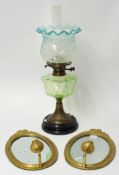 Pair of 20th century oval wall mirrors with candle stands, 32cm high t/w early 20th century oil lamp