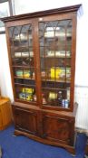 A Reprodux mahogany half glazed bookcase 101cm wide.