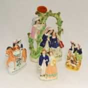 Four 19th century Staffordshire figures including `Arrival`, `Going to Market`, `Wedding` and `