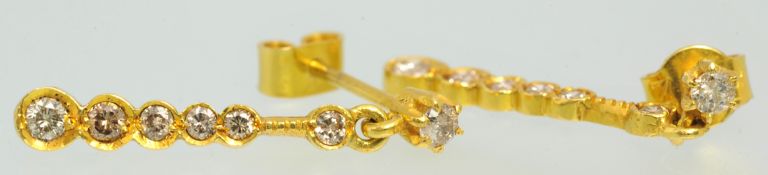 A pair of 18ct gold drop earrings set with diamonds, approximately 25mm long