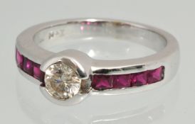 An 18ct diamond and ruby ring set in white gold, the centre stone with round brilliant cut