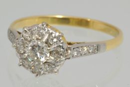 An 18ct gold diamond cluster ring, size S, set with an arrangement of round cut diamonds with