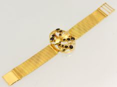 18ct yellow gold garnet bracelet, central oval open pierced floral leaf section set with twelve