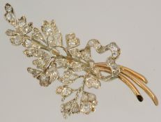 A floral spray brooch set throughout with diamonds mounted in yellow gold approximately 70mm long