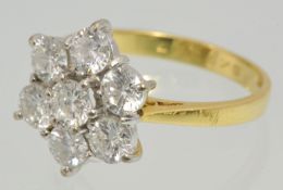 A fine diamond cluster ring set in 18ct yellow gold with an arrangement of seven round cut