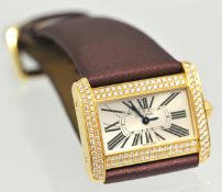A fine as new Ladies 18ct yellow gold rectangular Cartier Tank quartz wristwatch with silver Roman