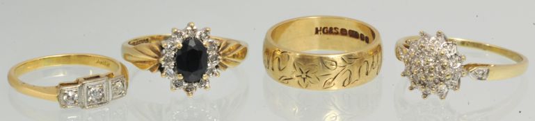 A 9ct gold wedding band and three other dress rings