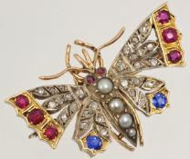 A butterfly brooch set with diamonds, sapphires, rubies and pearls in yellow gold approximately 40mm