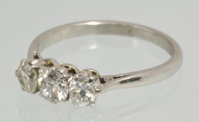 A platinum three stone diamond ring, size, L stamped `Plat`