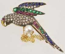 A parrot brooch set with diamonds, emeralds, rubies and sapphires set in yellow gold with single