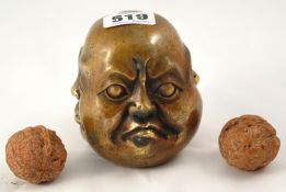 Reproduction bronze four faced Buddha, 10cm t/w pair of walnut kernels carved with various figures