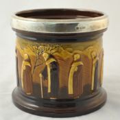 Royal Doulton pottery jar with silver rim with embossed decoration of seven monks in tree landscape,