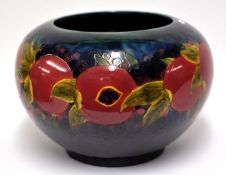 A reproduction of a Moorcroft jardinière approximately 25cm high decorated in the pomegranate