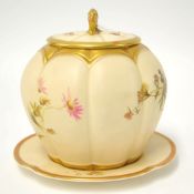 A Royal Worcester porcelain jar with cover, the cover with gilt handle, the cream lobed body with