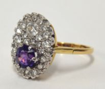 A fine 18ct diamond cluster ring, pave set with 25 diamonds and a single amethyst, ring size Q.