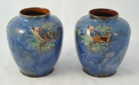 Pair of 20th century Royal Doulton Art pottery vases decorated with birds on a mottled blue ground