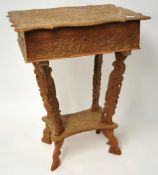 A Continental carved oak sewing table with fitted interior, 64cm high