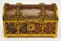 An ornate desk casket richly decorated in brass work and gilt leather having lined velvet interior