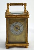 French brass carriage clock with 8 day movement, with travel case and key having ornate mouldings to