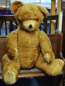 A large English teddy bear with `wood wool` filling, circa 1960/70`s, with growler approx 105cm tall