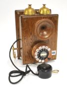 An antique wall telephone, the black mouth piece stamped L.M.Ericsson, 26cm long