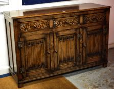 Reproduction oak and linen fold sideboard fitted with three drawers and cupboards