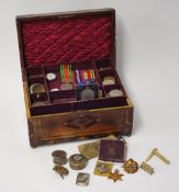 A parquetry inlaid sewing box containing various items including WWII medals, Commemorative coins,