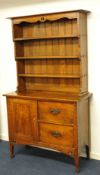 An oak dresser with open shelves, a base fitted with two drawers and cupboard, 107cm wide