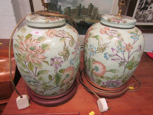 Pair of late 20th century ceramic table lamps formed as Chinese style jars, florally decorated and