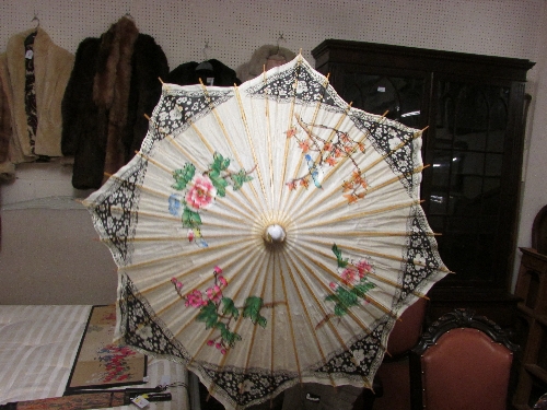 Tourist`s paper parasol with printed floral pattern
