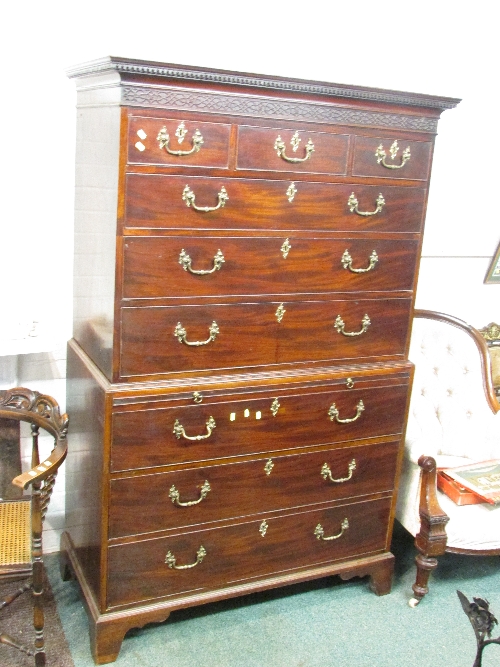 A good quality George III chest on chest with brush slide, dentil and blind fret cornicing, on