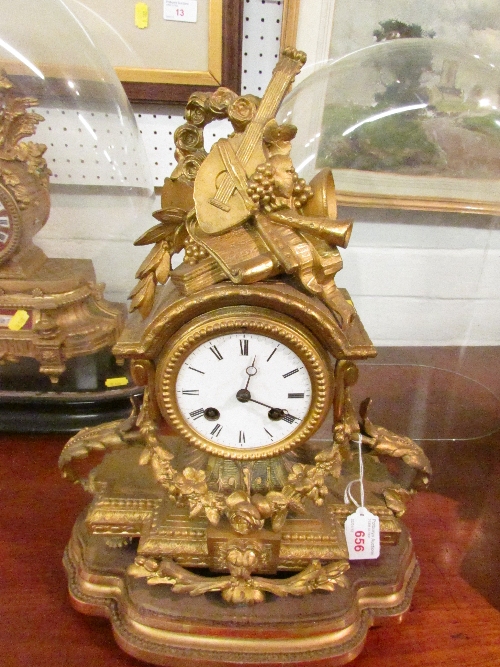 19th century gilded French Rococo-style chiming mantle clock with white enamel Roman numeral dial, a