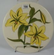 A Moorcroft charger decorated in the lily design with a Queen Mary paper label to reverse,