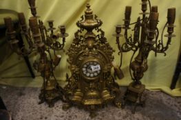 A French brass reproduction clock set comprising of mantle clock and pair of brass candleebreas (3)
