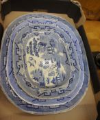 A collection of 3 large blue and white servers and meat plates.