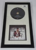 Robbie Williams signed plaque and album.