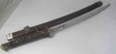 An Early Japanese Samurai Leather Bound Sword decorated with Gilt Metal Fittings and Ornate Tsuba