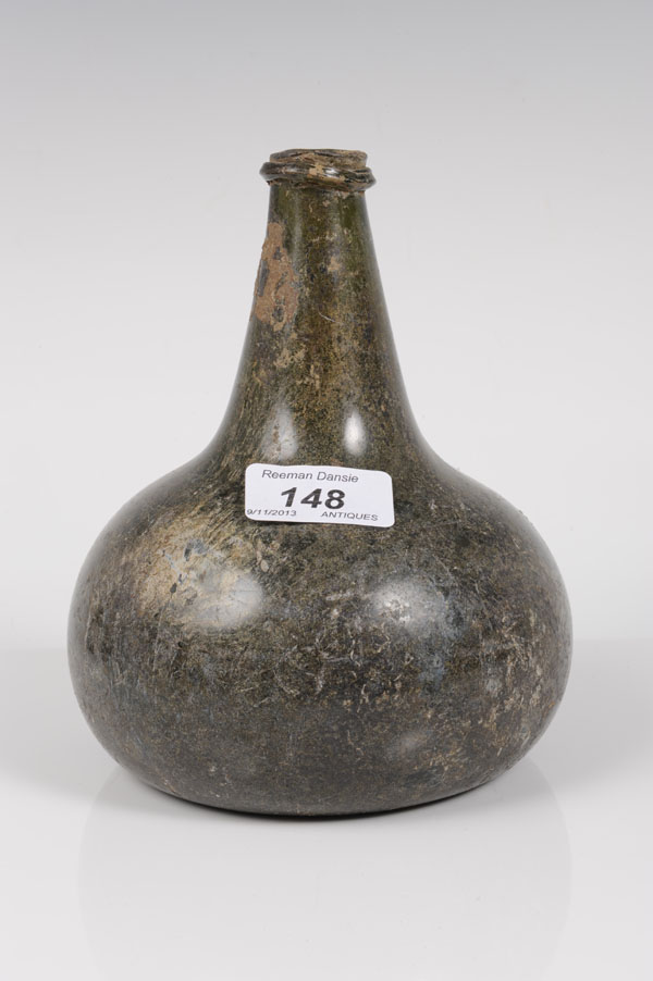 Late seventeenth / early eighteenth century green glass onion-shaped bottle with string collar to