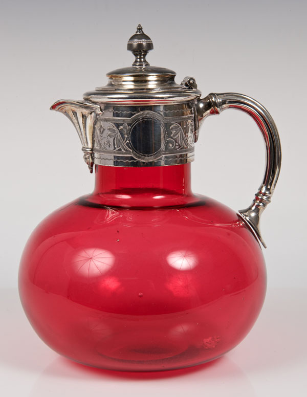 Victorian Cranberry glass claret jug of globular form, silver plated mount, with engraved foliate