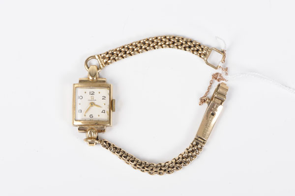 1950s ladies' Omega gold wristwatch with square dial, with black Arabic and gold dot hour markers,