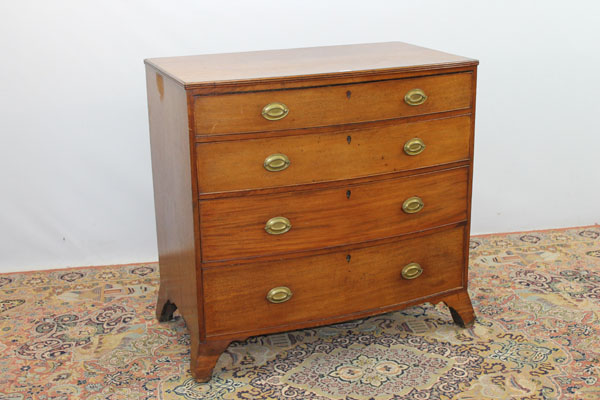 George III mahogany bow front chest of four long graduated drawers with oval brass handles, on
